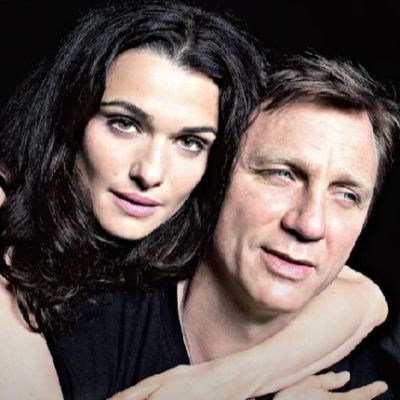 Rachel Weisz is hugging Daniel Craig from behind in this pic.